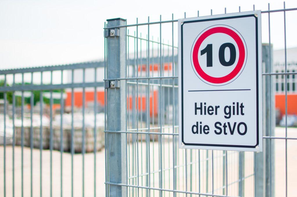 StVO-Schild mit Tempolimit auf Industriezaun | Macbook verkaufen